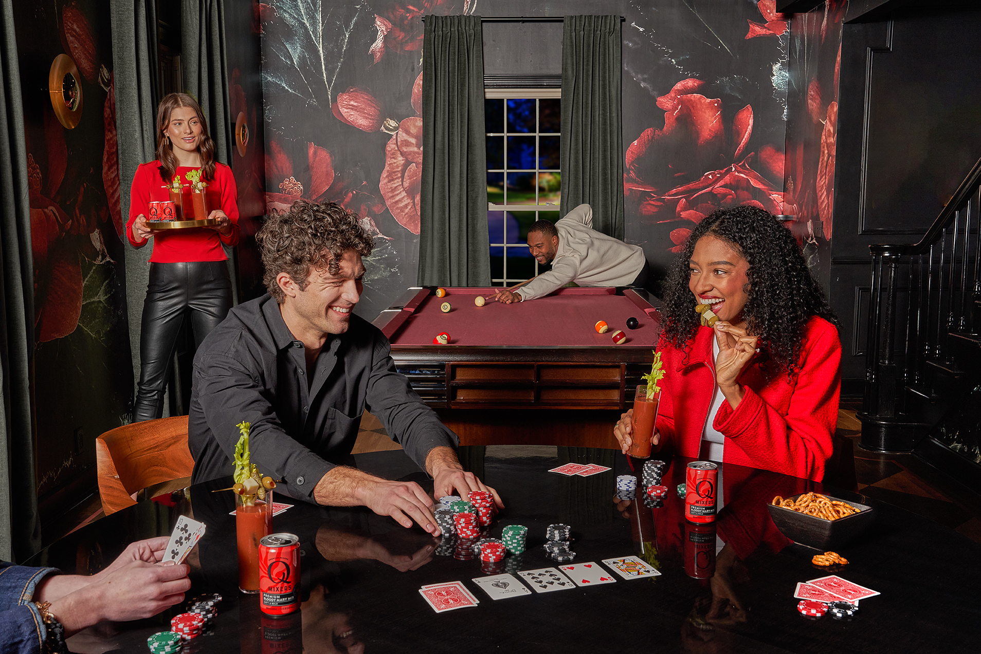 A group of friends playing billiards and cards while enjoying Q Mixers drinks.